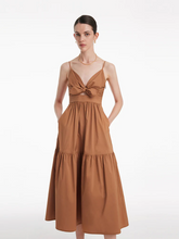 a lady in brown maxi v-neck strap dress